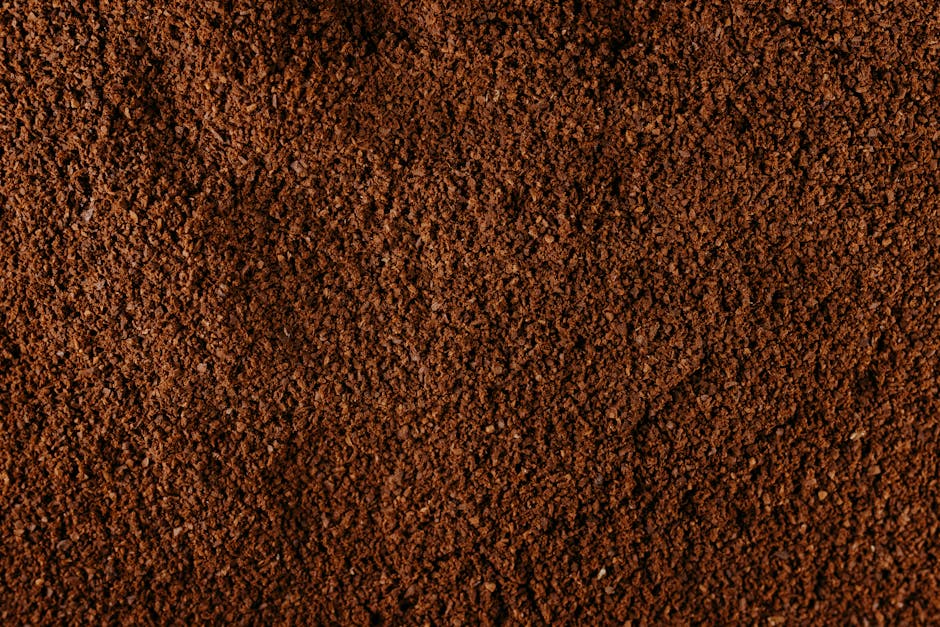 Close-up of coarse coffee grounds showing the rough, peppercorn-like texture ideal for cold brew and French press